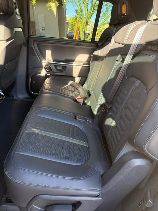 Rivian R1S second-row seats and extracted carpet after an interior detail