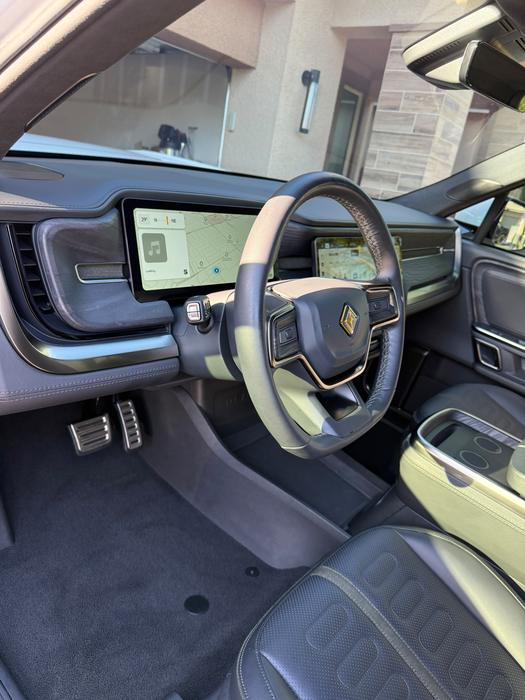 Rivian R1S driver cockpit with cleaned dash, screen and steering wheel after detailing