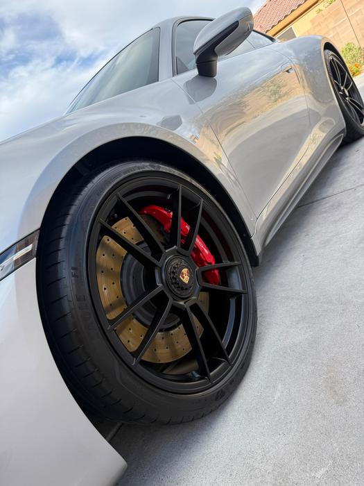 Silver Porsche 911 Turbo S side profile with cleaned centre-lock wheel and red calipers