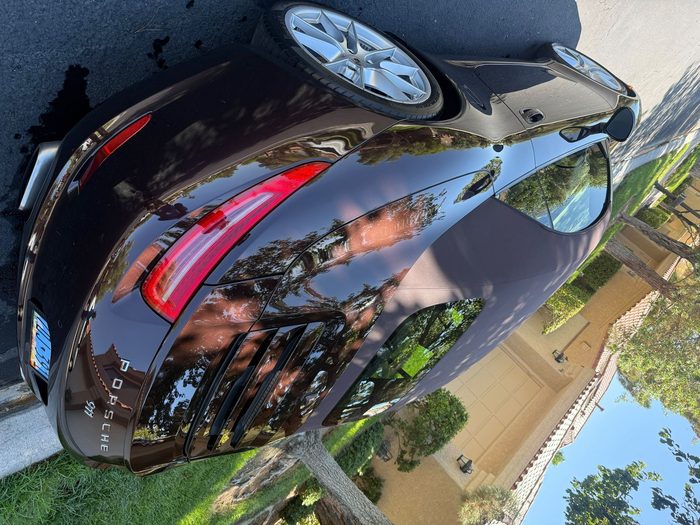 Dark metallic Porsche 911 Cabriolet rear end with mirror-flat corrected paint