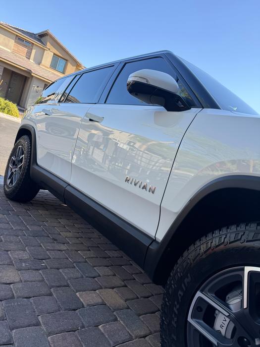 White Rivian R1S side profile with polished paint and dressed tires