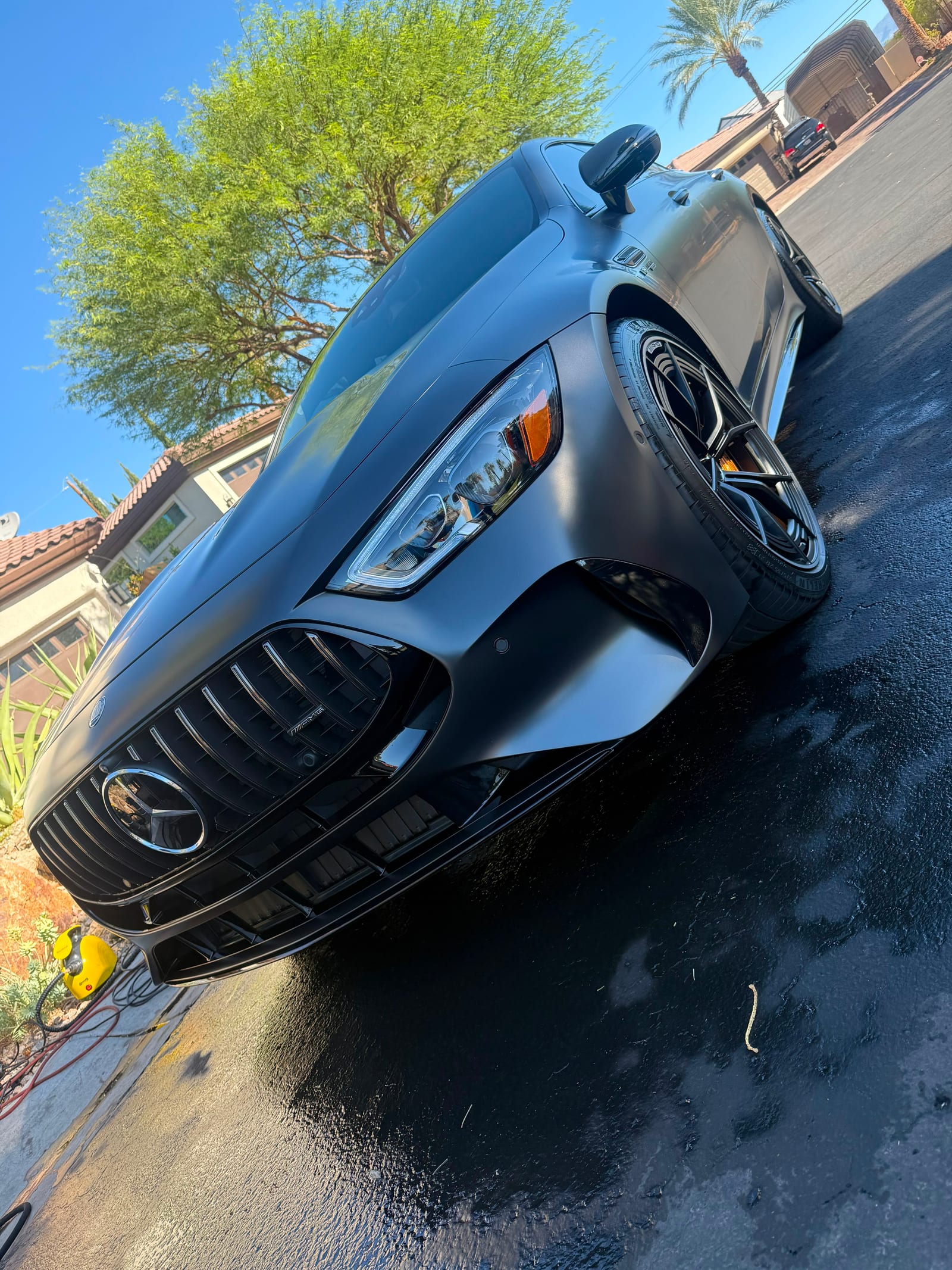 Matte grey Mercedes-AMG GT front end with grille and headlights cleaned after detailing