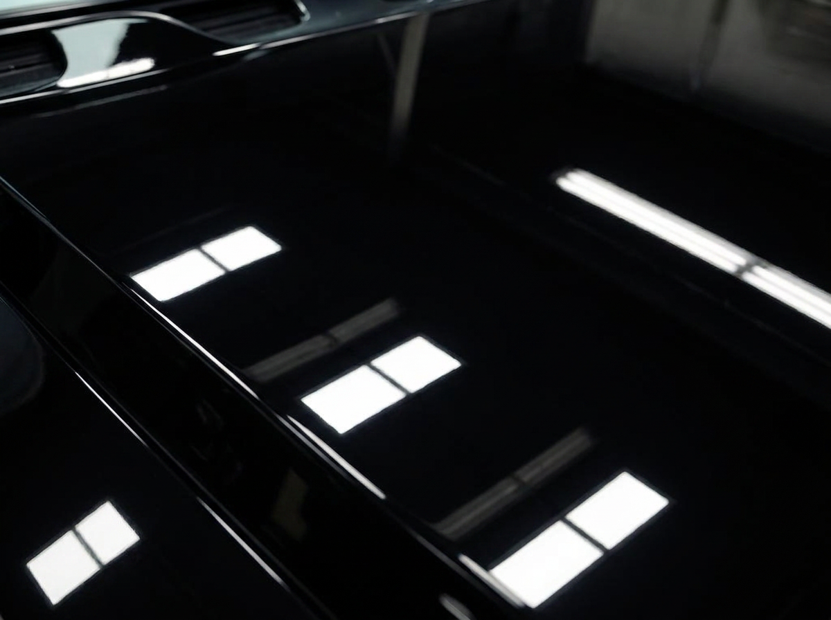 Swirled black paint corrected to a mirror finish — after detailing