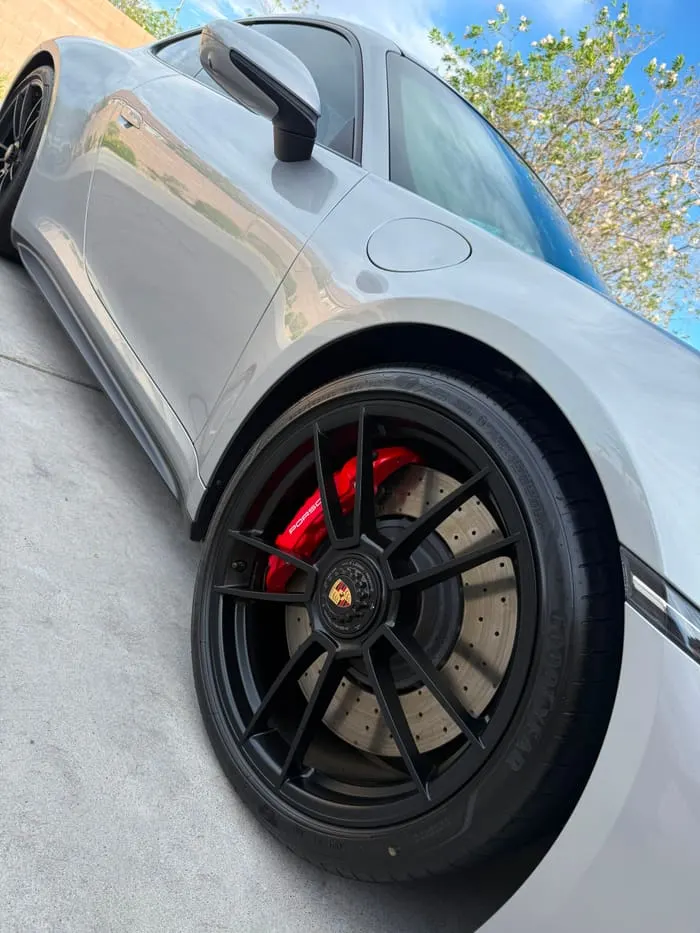 Porsche 911 Turbo S rear wheel, red calipers and carbon-ceramic disc after a deep clean