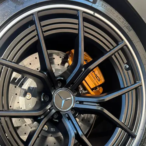 Detailed wheel and orange ceramic brake caliper on a Mercedes-AMG