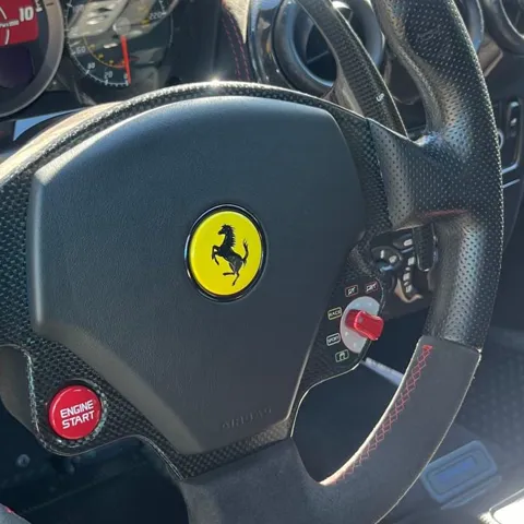 Ferrari badge and gauge cluster inside a detailed Ferrari F430