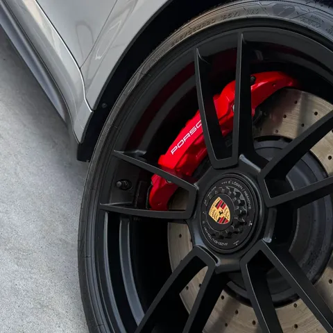 Detailed red brake caliper and wheel face on a Porsche 911